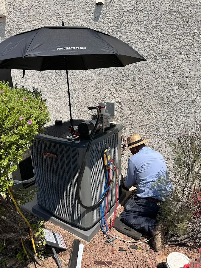 HVAC technician performing outdoor AC maintenance in Palo Alto